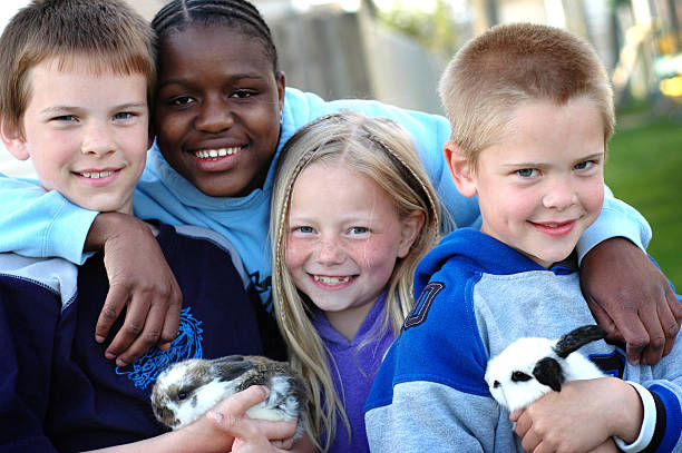 Four Happy Children and Two Bunnies