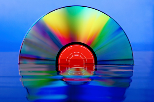 DVD medium on a Blue background with water reflection.