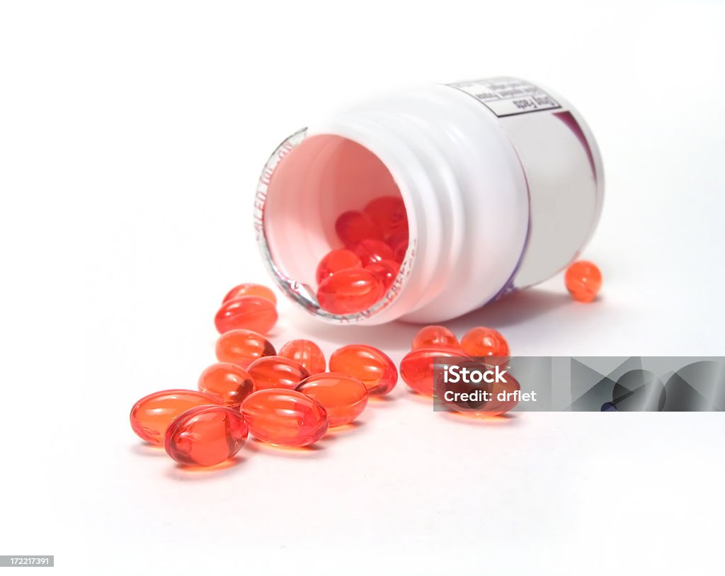 Bottiglia di pillole rosso - Foto stock royalty-free di Barattolo di vetro