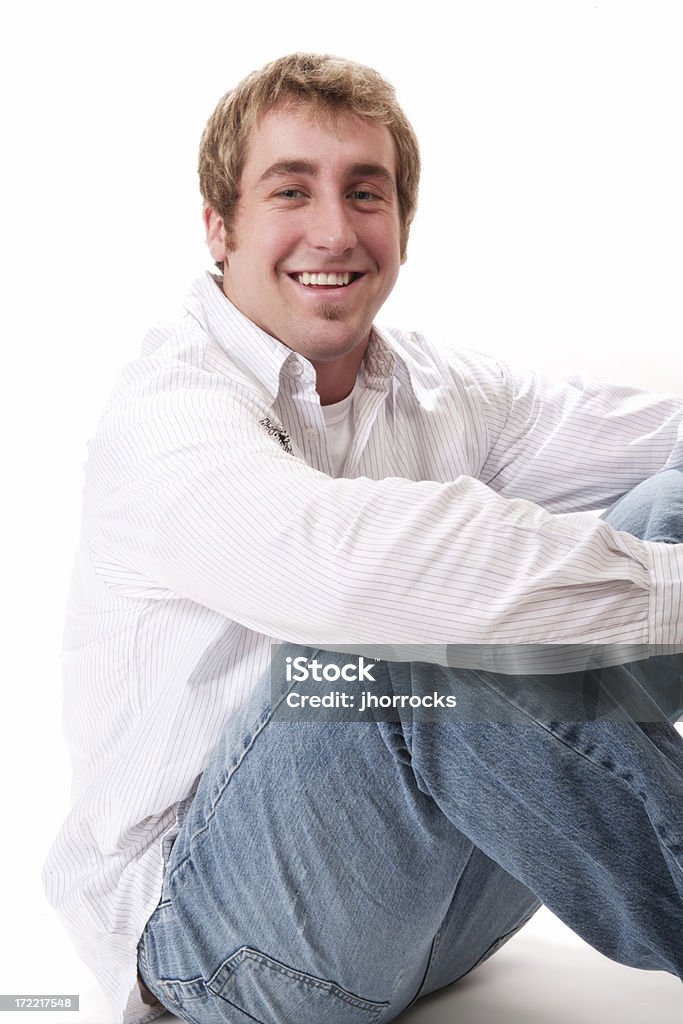 Casual Male Sitting on Floor "Photo of a handsome young man sitting on the floor, holding his knees..." 20-29 Years Stock Photo