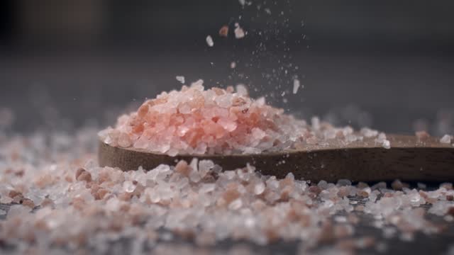 Himalayan pink salt in a wooden is used to flavor food. Due mainly to marketing costs, pink Himalayan salt is up to twenty times more expensive than table or sea salt.