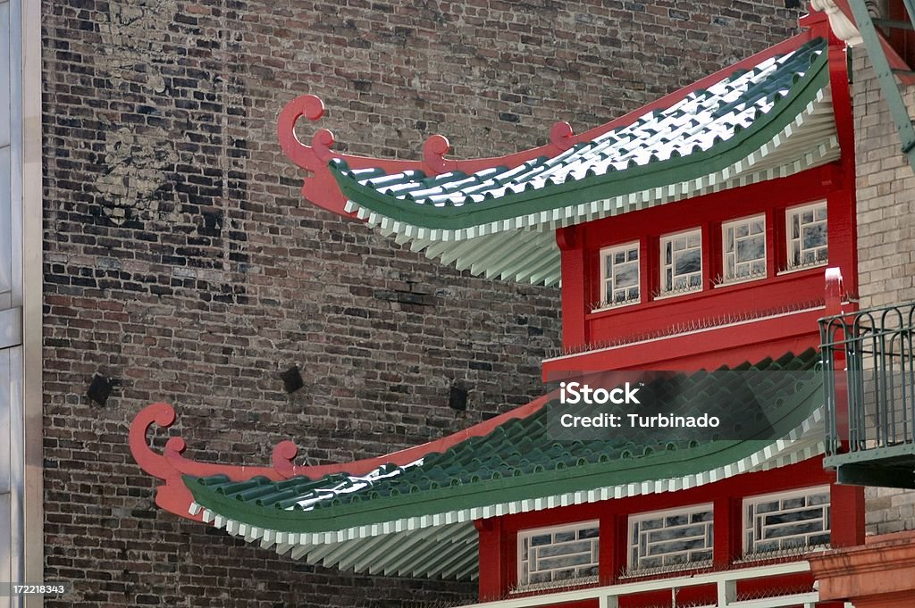 Asian architecture Asian architecture juxtaposed against Western-looking brick wall.  Can be used to symbolize an intermingling or mixing of cultures or societies. San Francisco - California Stock Photo
