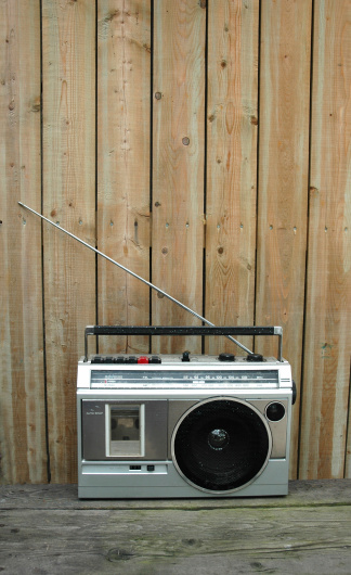 Portable cassette  transistor radio with the wooden fence background