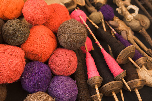 Alpaca, Llama wool yarn balls and spindles, colorful, beautiful textiles for spinning and weaving, at the Pisac market, Peru, South America.