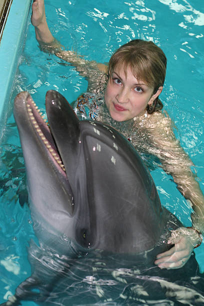 istock nice girl and kind dolphin 172219842