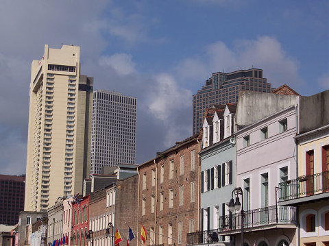 Street scene from the French Quarter in New Orleans, Louisiana, USA. Downtown skyscrapers towering over centuries-old architecture.