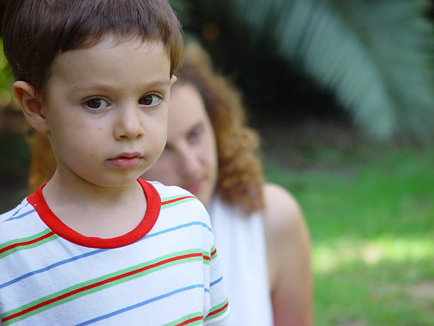 istock Serious Child with Mother in background 172221103
