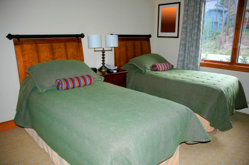 Two twin beds in a bedroom.