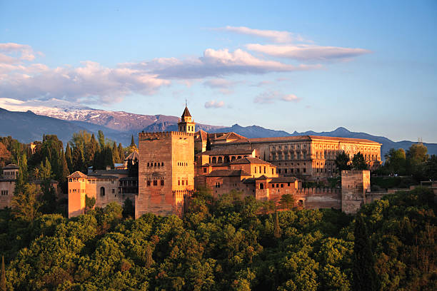 Alhambra in Granada at twilight. One the 7 New Wonders "Many people say that this is one of the most beautiful places of the world, specially on late afternoon, where you find the covered with snow mountain of Sierra Nevada, and the red light coming from the sun at twilight" granada spain stock pictures, royalty-free photos & images