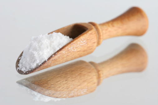 salt in spatula isolated over reflective surface