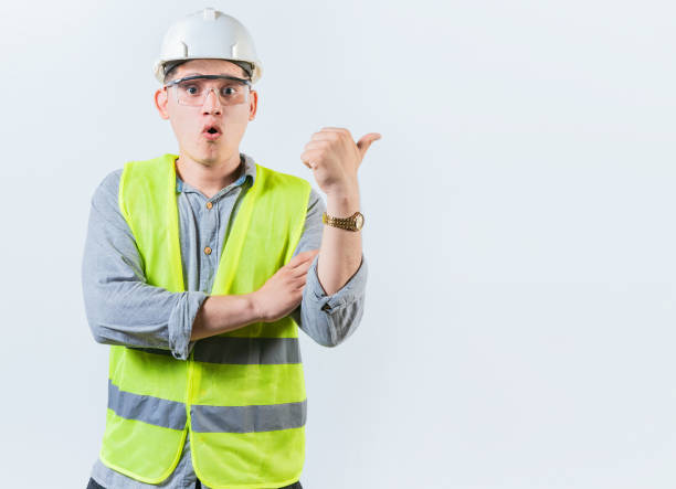istock Portrait of surprised engineer man pointing side. Amazed engineer pointing advertising to side isolated. Construction worker pointing at an advertisement side 1722224912