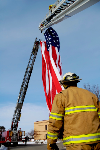 Fireman raising flag for celebration
