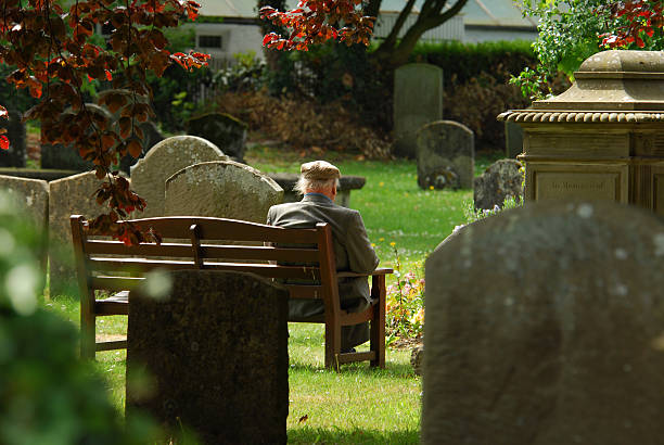 Elderly Man in a Graveyard stock photo
