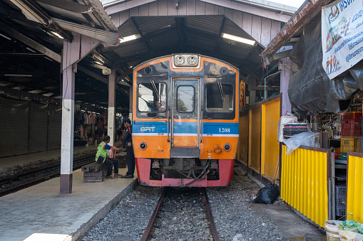 A Thai Train at the Railway Station Mahachai Market Mueang Samut Sakhon District in the immediate vicinity of Bangkok in Thailand Asia.\nThis train connection between Samut Sakhon and the capital Bangkok is operated several times a day.\nSamut Sakhon Thailand Southeast Asia\n10/07/2023