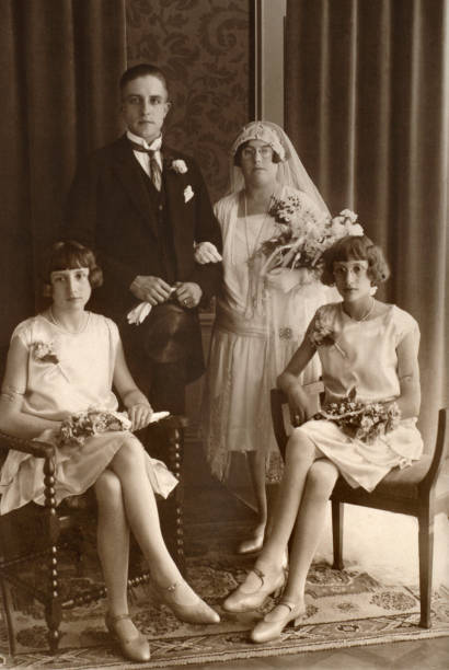 Wedding from the thirties or twenties Old photograph with bride,groom and two bridesmaids. wedding dress photos stock pictures, royalty-free photos & images