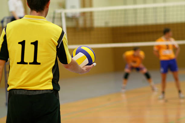 Volleyball "volleyball in the hand of a male playerShallow depth of field, focus is on the ball" male volleyball player stock pictures, royalty-free photos & images