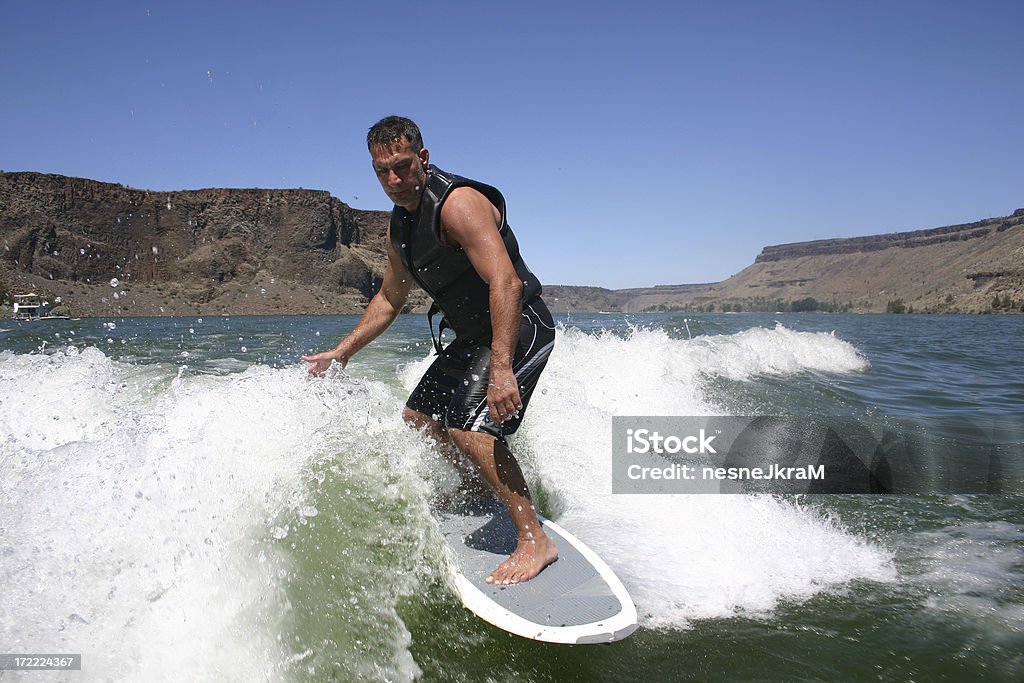 Surfing the Wake. Surfing the wave created by a wake board boat on Lake Billy Chinook in Central Oregon. 30-39 Years Stock Photo
