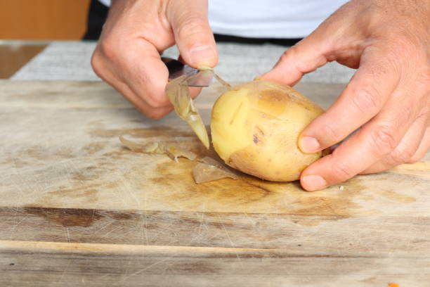 istock Removing skin of boiled potato 1722244081