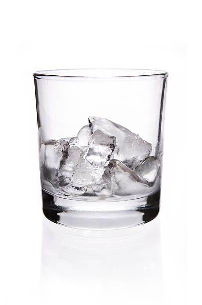 Ice cubes in whisky glass stock photo