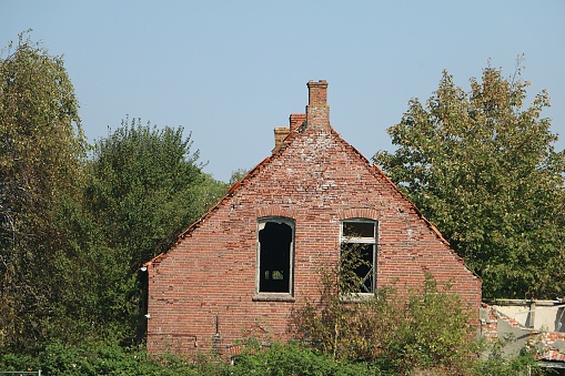 A view from a damaged building into the countryside that the building overlooks
