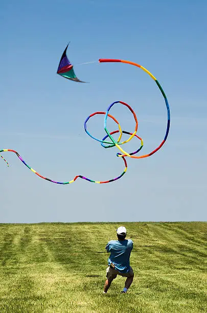 Man doing tricks with his kite on a windy day.