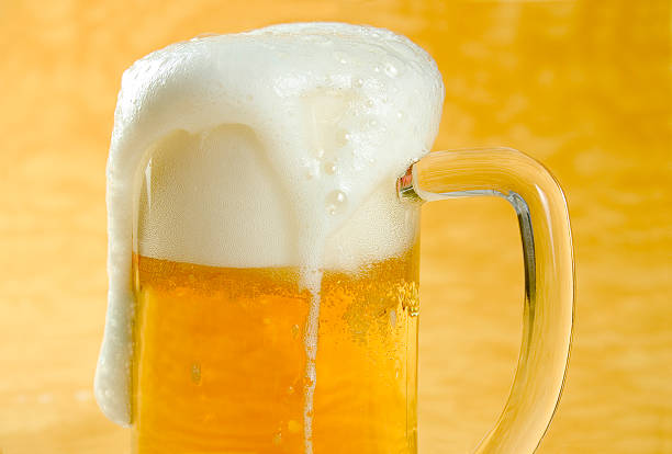 Mug full of Beer "Glass of Beer, brown backgroundGlasses of Beer:" froth beer bubble quencher stock pictures, royalty-free photos & images