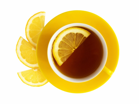 Cup of tea and slices of lemon.