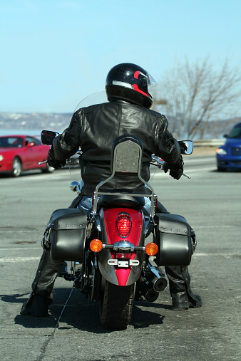 Fully outfitted biker with new bike waits for the light to change at a traffic intersection.
