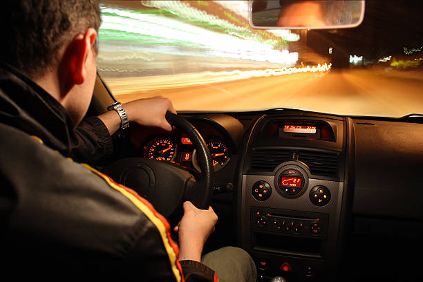 Fast night drive The photo shows a man driving a sports car  speedometer photos stock pictures, royalty-free photos & images