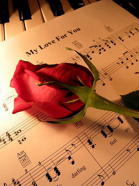 Rose with ribbon and treble clef symbol on sheet music