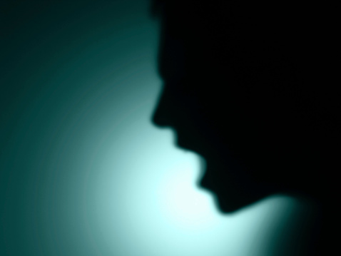 defocused shadow of a man shouting in hue effect