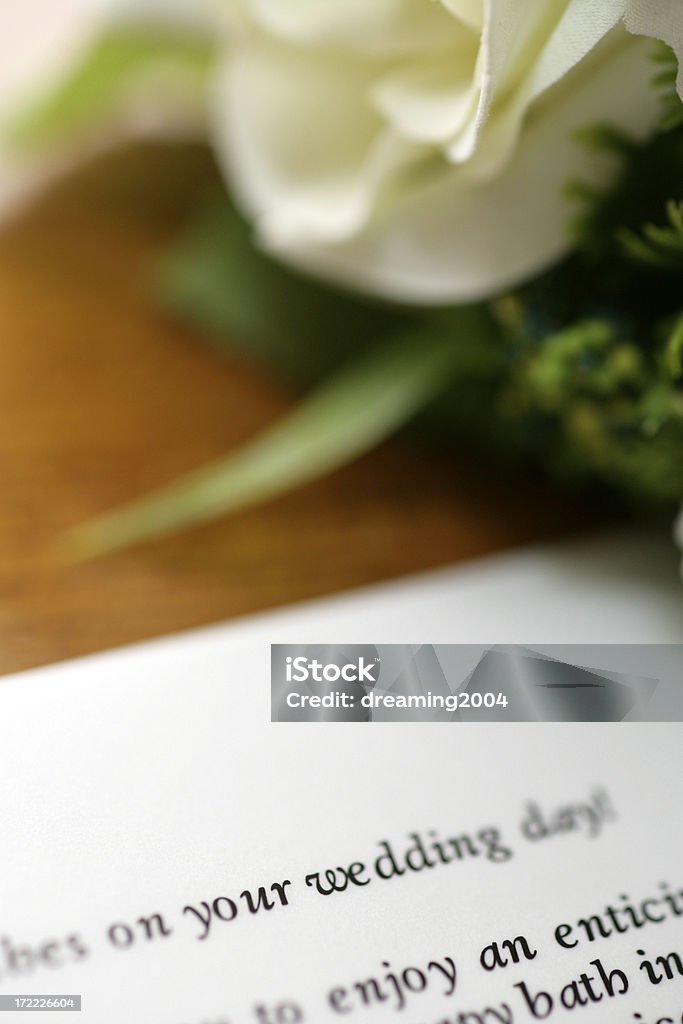 wedding invitation and rose A wedding invitation and white rose on table. Celebration Stock Photo