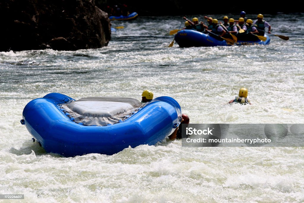 It Happens "Rafts flip and rafters swim, fortunately life jackets keep rafters form getting pinned under rocks most of the time." Rafting Stock Photo