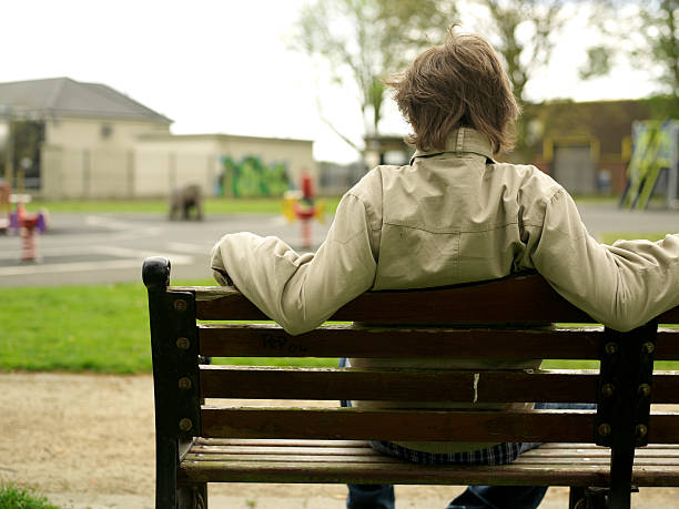 istock man on a bench at the park 172226833