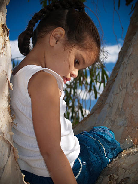 contemplating life young girl sitting in tree contemplating life maori weaving stock pictures, royalty-free photos & images