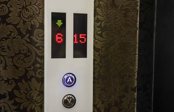 istock Elevator direction control buttons, up, down, illuminated neon blue. Screen of an elevator lift indicating the floor number. Concept for mall, hotel, office, tower, high rise building. 1722269135