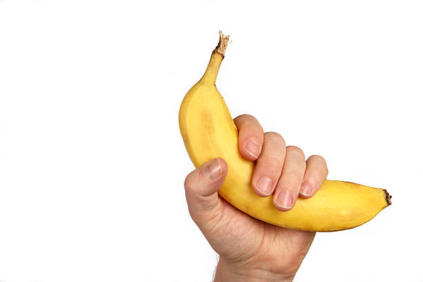 Man's hand, holding a nice fresh banana.