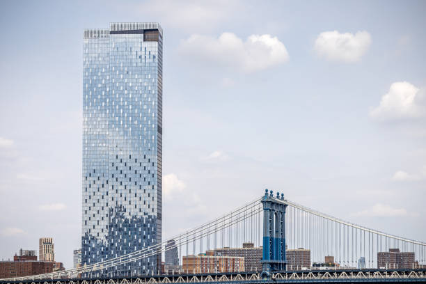 Manhattan bridge over East river. View from Brooklyn, Dumbo side through buildings. New York, USA