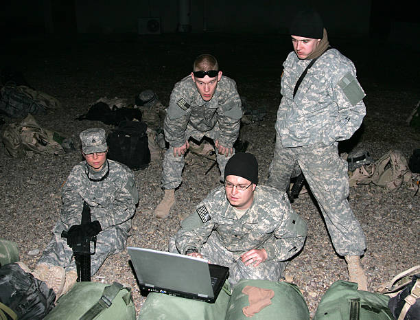 ooh, laptop Jeff entertains the other guys with movies on his laptop while they wait for a helicopter somewhere in Baghdad. female combat soldier stock pictures, royalty-free photos & images