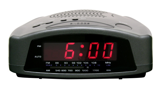 Wake up, it's 6AM! This digital alarm clock radio does the job. With clipping path.