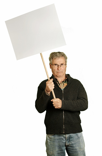 angry mature man holding a protest sign.