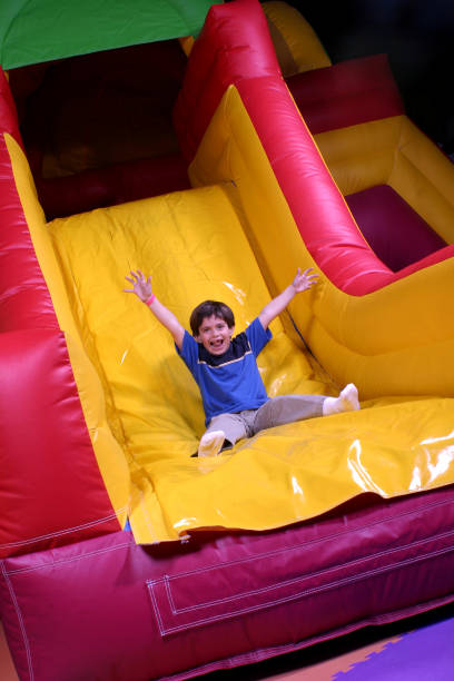 istock Boy on inflatable slide goes fast 172229322