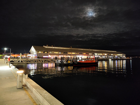 The Elizabeth Street pier by night in Hobart's harbour, the capital city of Tasmania, Australia.