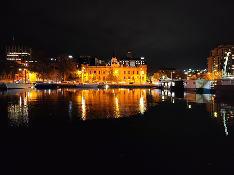 Building reflecting on Hobart's harbour by night, Tasmania, Australia.