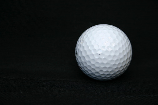 White Golf Ball on a Black Background