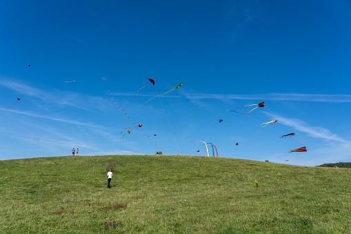 Moen, Denmark - September 9, 2023: Colourful kites and people at the annual Kite Festival on the island Moen