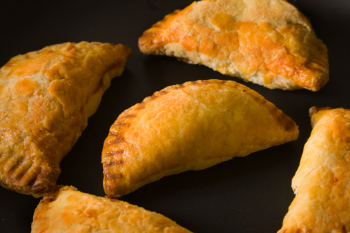 Subject: Empanada, a favorite Central and South American appetizer, in a black baking pan