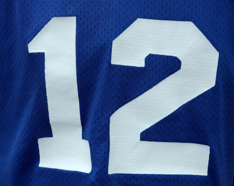 Close up of a number 12 on a football jersey.