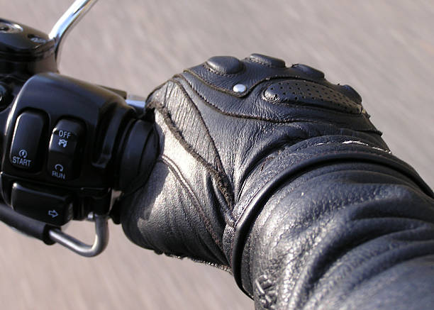 Hand on the Throttle (2) Leather gloved hand squeezing the throttle of a motorcycle. Focus point is on top of glove. throttle stock pictures, royalty-free photos & images