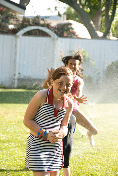 istock Child Playing in Yard with Water from Sprinklers 172231261